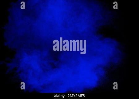 Blue powder explosion cloud on black background.Launched blue dust particle splash. Stock Photo
