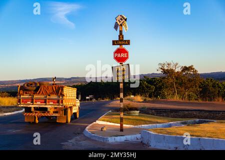 Goiania, Goias, Brazil – July 10, 2022: A truck passing through the railway crossing in the city of Bonfinópolis in Goiás, which has dented signs. Stock Photo