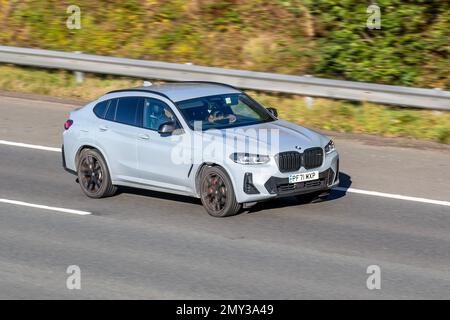 2022 BMW X4 M400D MHEV AUTO XDRIVE0D M SPORT Electric Diesel 8 speed automatic; travelling on the M61 motorway UK Stock Photo