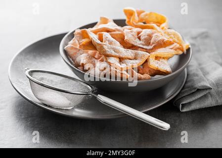 Traditional sweet crisp pastry - faworki or angel wings, deep-fried and sprinkled with powdered sugar Stock Photo