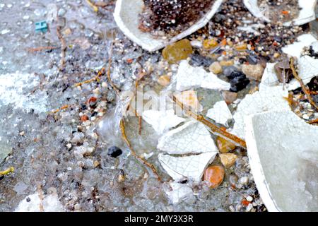 Rain crashes into a small puddle Stock Photo