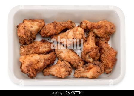 Pre-cooked fried chicken wings in plastic food tray for supermarket sale , isolated on white with clipping path Stock Photo