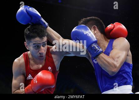 Thailand's Chatchai Butdee, left, fights Britain's Qais Ashfaq during a
