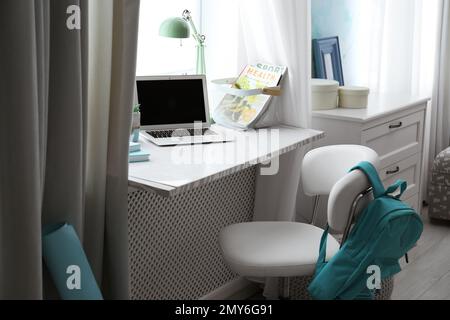 Comfortable workplace with laptop on window sill at home Stock Photo