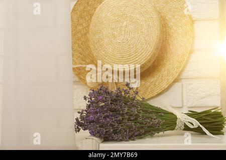 Beautiful lavender bouquet and straw hat indoors Stock Photo