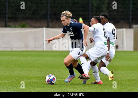 Swansea, Wales. 4 February 2023. Aimar Govea of Swansea City under pressure  from Finley Cotton of Millwall during the Professional Development League  game between Swansea City Under 18 and Millwall Under 18