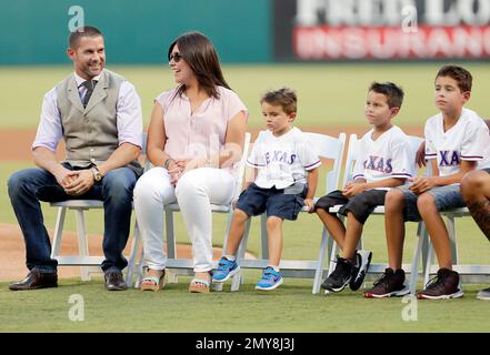 Former Texas Rangers' Michael Young, sits by his wife Cristina