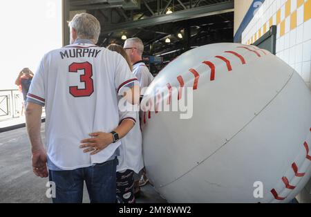 Former Atlanta Braves player Dale Murphy tips his hat to cheering fans  before a spring baseball exhibition game against the Miami Marlins, Friday,  March 15, 2019, in Kissimmee, Fla. (AP Photo/John Raoux