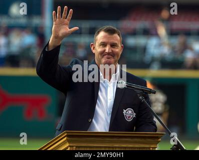 Former Oakland Athletics star and Hall of Famer Reggie Jackson, left,  stands with Josh Reddick in right field and acknowledges the crowd as the  1973 World Series championship team is honored in