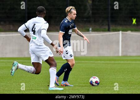 Swansea, Wales. 4 February 2023. Aimar Govea of Swansea City under pressure  from Finley Cotton of Millwall during the Professional Development League  game between Swansea City Under 18 and Millwall Under 18