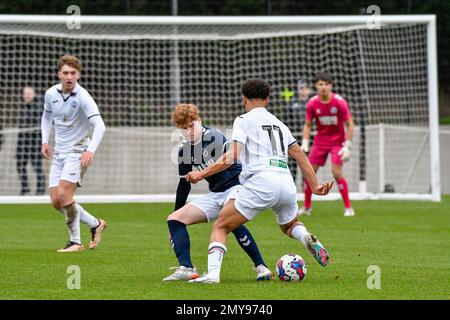 Swansea, Wales. 4 February 2023. Oliver Evans of Millwall under pressure  from Zane Myers of Swansea City during the Professional Development League  game between Swansea City Under 18 and Millwall Under 18