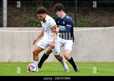 Swansea, Wales. 4 February 2023. Oliver Evans of Millwall under pressure  from Zane Myers of Swansea City during the Professional Development League  game between Swansea City Under 18 and Millwall Under 18