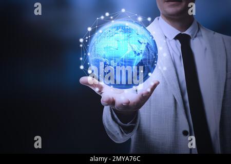 Business analytics. Man demonstrating virtual image of globe with network connection, closeup Stock Photo