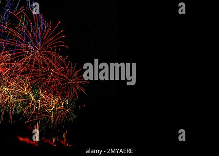 Fireworks banner. Copy space. New Year and Celebration banner. Sparks salute isolated on black background. Festive banner with flashes of fireworks Stock Photo