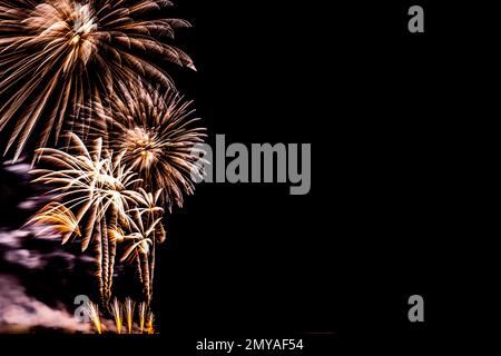 Fireworks banner. Copy space. New Year and Celebration banner. Sparks salute isolated on black background. Festive banner with flashes of fireworks Stock Photo
