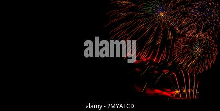 Fireworks banner. Copy space. New Year and Celebration banner. Sparks salute isolated on black background. Festive banner with flashes of fireworks Stock Photo
