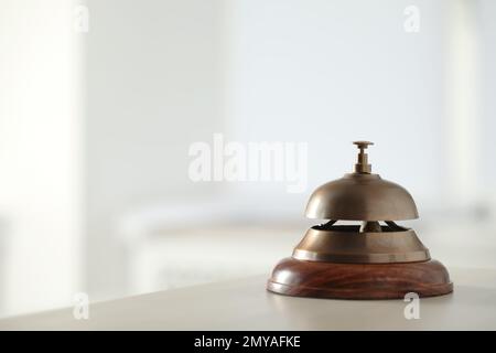 Hotel service bell on table indoors. Space for text Stock Photo