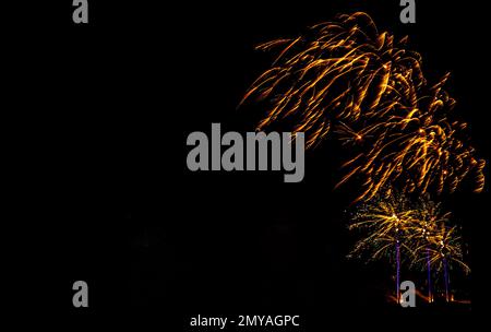Fireworks banner. Copy space. New Year and Celebration banner. Sparks salute isolated on black background. Festive banner with flashes of fireworks Stock Photo