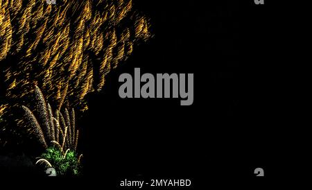Fireworks banner. Copy space. New Year and Celebration banner. Sparks salute isolated on black background. Festive banner with flashes of fireworks Stock Photo