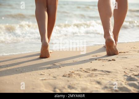 Young couple walking together on beach, closeup Stock Photo