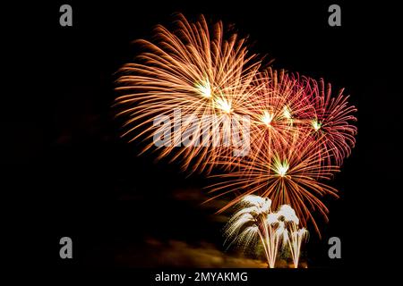 Fireworks banner. Copy space. New Year and Celebration banner. Sparks salute isolated on black background. Festive banner with flashes of fireworks Stock Photo