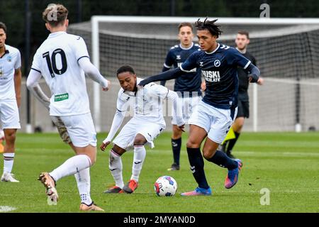 Swansea, Wales. 4 February 2023. Aimar Govea of Swansea City under pressure  from Finley Cotton of Millwall during the Professional Development League  game between Swansea City Under 18 and Millwall Under 18