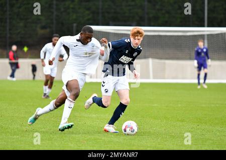 Swansea, Wales. 4 February 2023. Richard Faakye of Swansea City holds off  the challenge from Jack Howland of Millwall during the Professional  Development League game between Swansea City Under 18 and Millwall