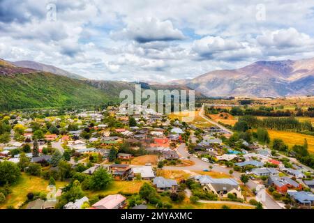 Historic Arrowtown in New zealand mountain region of Otago by Arrow river in aerial landscape. Stock Photo