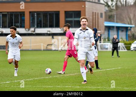 Swansea, Wales. 4 February 2023. Iwan Morgan of Swansea City high fives  Aimar Govea of Swansea City during the Professional Development League game  between Swansea City Under 18 and Millwall Under 18