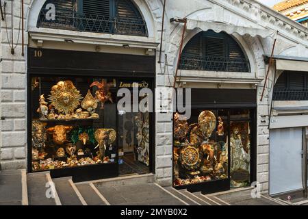 Exterior and shop windows of a Venetian mask shop on the Rialto Bridge empty at dawn, Venice, Veneto, Italy Stock Photo