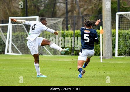 Swansea, Wales. 4 February 2023. Richard Faakye of Swansea City holds off  the challenge from Jack Howland of Millwall during the Professional  Development League game between Swansea City Under 18 and Millwall