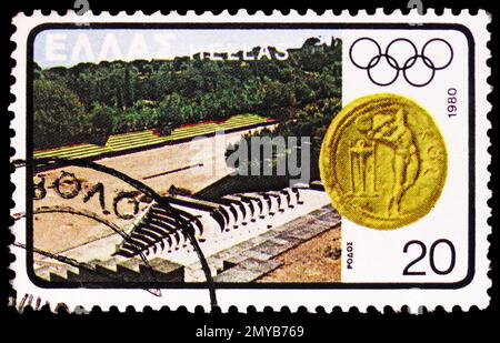 MOSCOW, RUSSIA - FEBRUARY 2, 2023: Postage stamp printed in Greece shows Rhodes Stadium, Coin from Kos, Summer Olympic Games 1980 - Moscow serie, circ Stock Photo