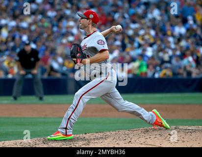 Washington Nationals' Max Scherzer and his wife Erica, second from right,  holding their daughter Brooklyn, stand on the field before a baseball game  against the Arizona Diamondbacks, Sunday, June 16, 2019, in