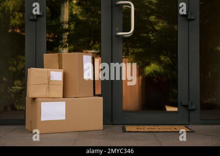 Delivered parcels on porch near front door Stock Photo