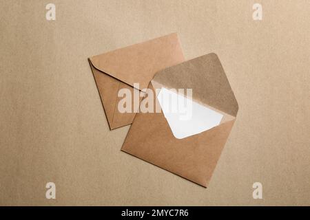 Brown paper envelopes on color background, flat lay Stock Photo