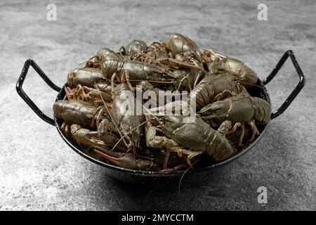Fresh raw crayfishes on grey table. Healthy seafood Stock Photo