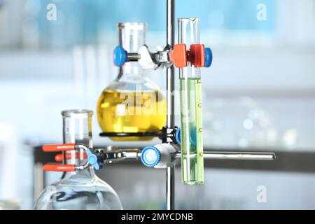 Laboratory clamp stand with glassware, closeup view Stock Photo