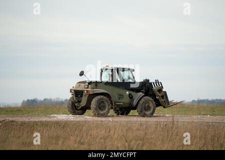 British army JCB fork lift truck driving a dirt track on a military exercise, Wiltshire UK Stock Photo