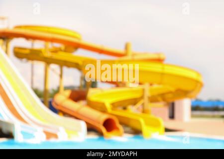 Different colorful slides in water park, blurred view Stock Photo