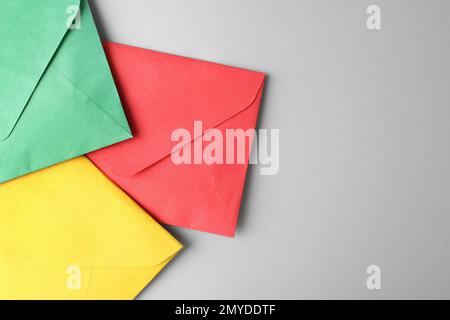 Colorful paper envelopes on light grey background, top view. Space for text Stock Photo