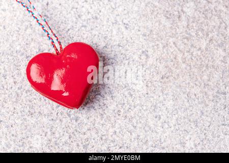 Red toy heart on granite stone textured background. Valentines day concept. Top view, flat lay, copy space. Stock Photo