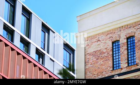 View of an modern apartment building standing next to a new modern office building with a glass facade. Stock Photo
