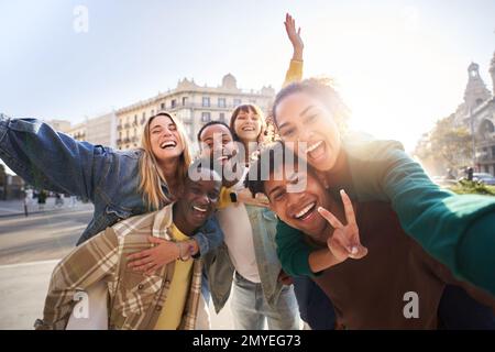 A group of cheerful students college friends taking a selfie as they travel through European cities. Stock Photo