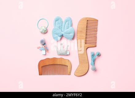 Flat lay composition with wooden hair combs on pink background Stock Photo