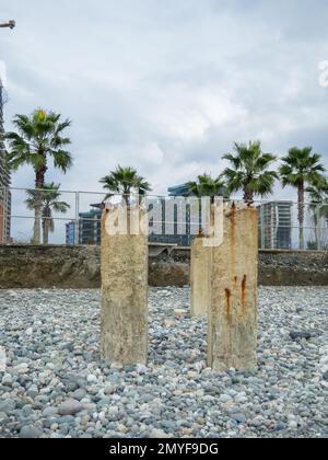 Reinforced concrete pile sticking out of the ground. Construction on the beach. Abandoned. Armature at sea. Destroyed building. building Stock Photo