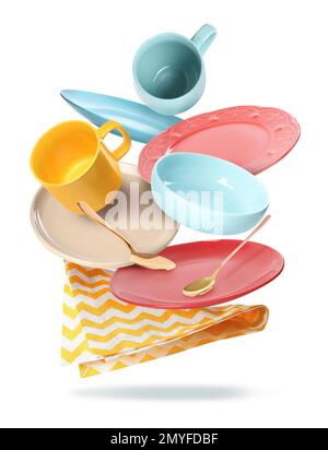 Set of clean tableware and napkin in flight on white background Stock Photo