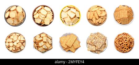 Set of different tasty crackers in bowls on white background, top view Stock Photo