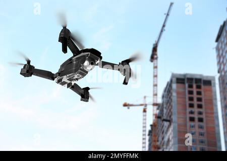 Modern drone flying at building site. Aerial survey Stock Photo