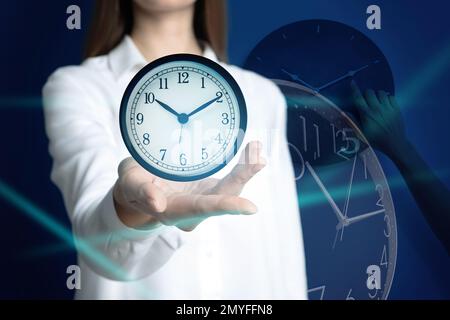 Time management concept. Woman with clock, closeup Stock Photo