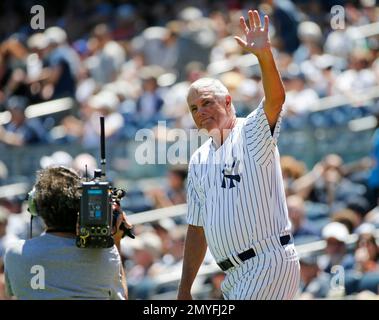 Former New York Yankees player Tino Martinez waves to the crowd